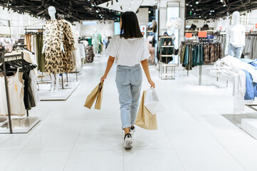 Woman with cardboard bags, clothing store