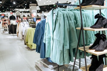 Wall Mural - Clothes, coats on racks in clothing store, nobody