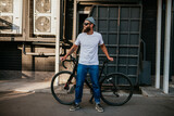 Fototapeta  - Young bearded hipster guy wearing white blank t-shirt with bicycle . Mock-up for print. T-shirt template.