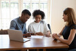 © fizkes - Excited African American husband and wife sit at desk meet with female agent close deal sign agreement, happy biracial couple put signature on contract document consult with realtor in office