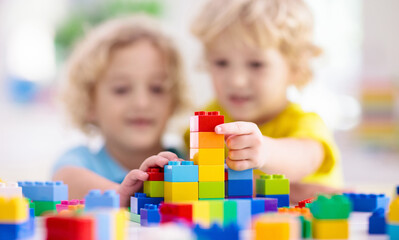 Child playing with toy blocks. Toys for kids.