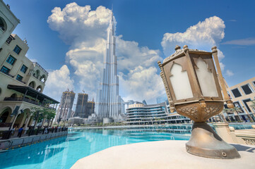 Burj Khalifa with Dubai mall next to it and water reflection of the skycraper in Dubai.