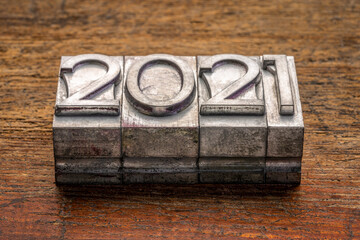 2021 year in vintage, gritty letterpress metal type against rustic, weathered wood