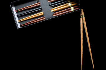 realistic chinese chopsticks isolated on black background for food in box, store delivery, menu