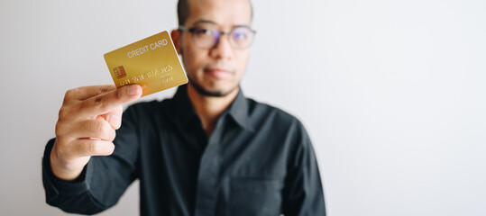 Businessman showing gold credit card isolated on white background.