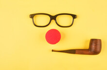 Black Glasses And Clown Nose Forming A Face. Red Nose Day Concept