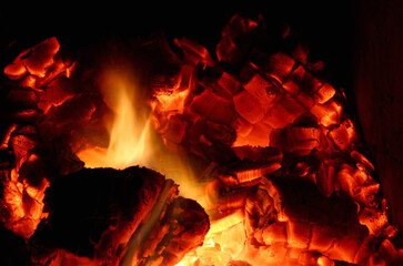 hot coals burning down in a stone oven
