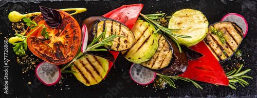 Tasty grilled vegetables on pan on dark background. Healthy food, summer food concept. © qwasder1987