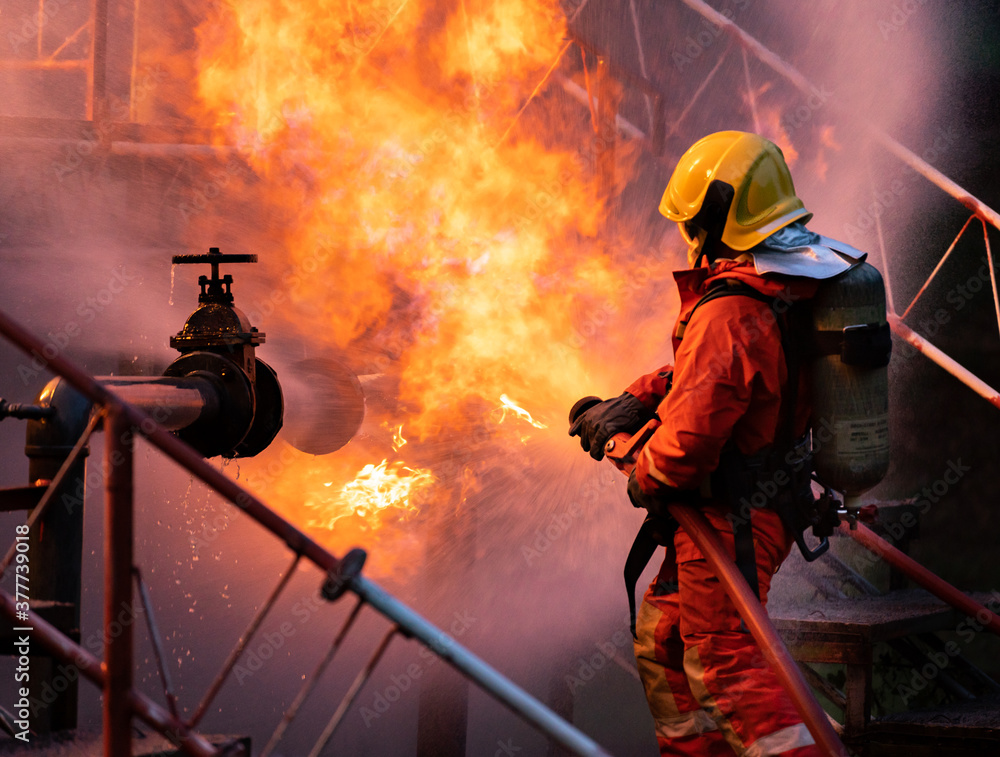 Oil Rig Spraying Firefighters using water fog spraying down fire from oil rig factory ...