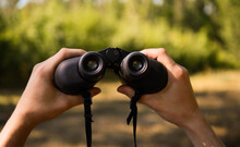 Hands Holding Binoculars. Forest Hiking. Bird Watching. Searching For Opportunities Concept. Adventure Quest