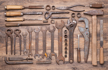 Wall Mural - Collection of vintage tools such as wrenches, hammer, chisels and other on old wooden background, top view