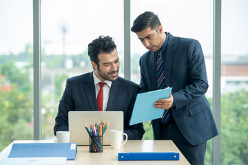 Serious businessman listening to his colleague explanations at meeting at modern office,Partnership concept.