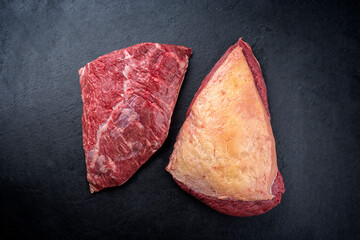 Wall Mural - Raw dry aged wagyu cap of rump beef offered as top view on black background with copy space