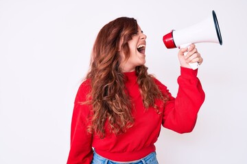 Wall Mural - Young beautiful brunette woman screaming using megaphone over isolated white background