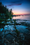 Fototapeta Na ścianę - Vertical Silhouette of Sunset on Huron Lake in Tobermory, Canada, Ontario