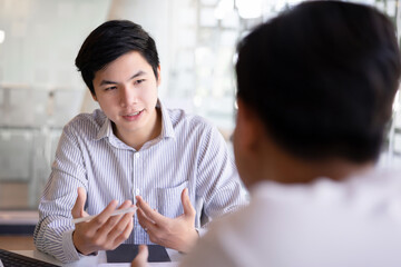 Two business people talking in cafe and discussing business project.