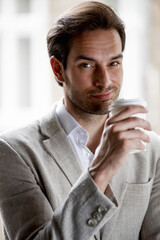 Young businessman having a break an drinking a beverage