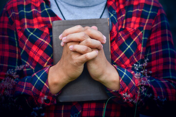 Poster - A Man praying holding a Holy Bible. christian concept.