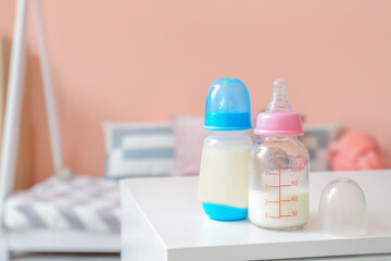 Canvas Print - Bottles of milk for baby on table in room