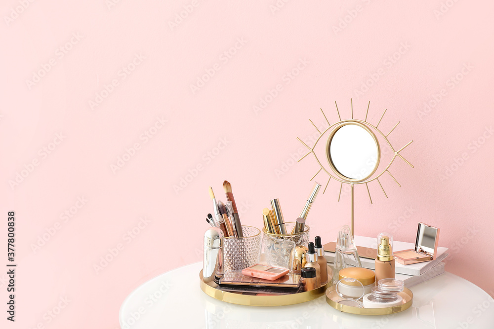 Set of decorative cosmetics and mirror on dressing table