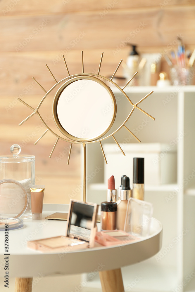 Set of decorative cosmetics and mirror on dressing table