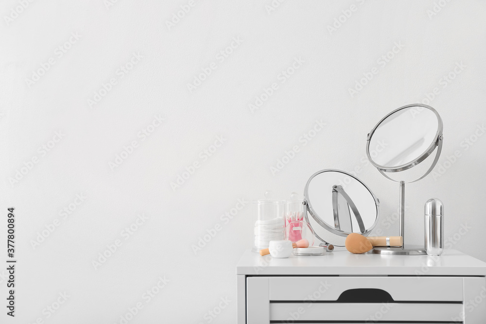 Set of decorative cosmetics and mirrors on dressing table