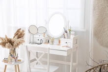 Set Of Decorative Cosmetics On Dressing Table In Room