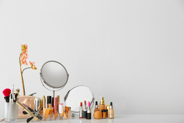 Set of decorative cosmetics and mirrors on dressing table