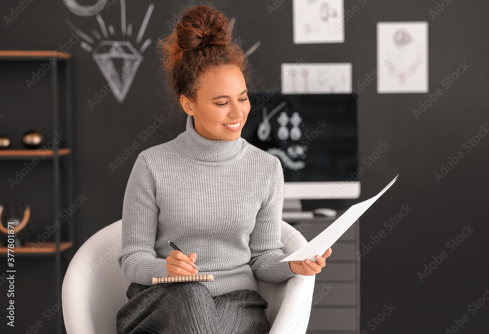 Female jewelry designer working in office