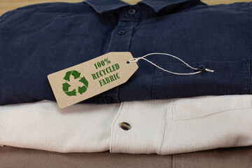 Wall Mural - Mens shirts with Recycle clothes icon on label with 100% Recycled fabric text. Sustainable fashion and ethical shopping to reduce waste concept