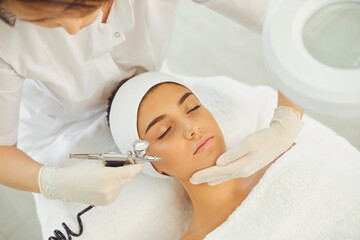 beautiful woman getting procedure of oxygen therapy in beauty salon