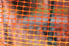 Close-up Of An Orange Plastic Mesh. Temporary Fence For Renovation Work