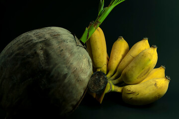 Art background coconut, banana, spoon, dish