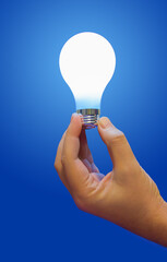 Sticker - Lighting lamp in hand on blue