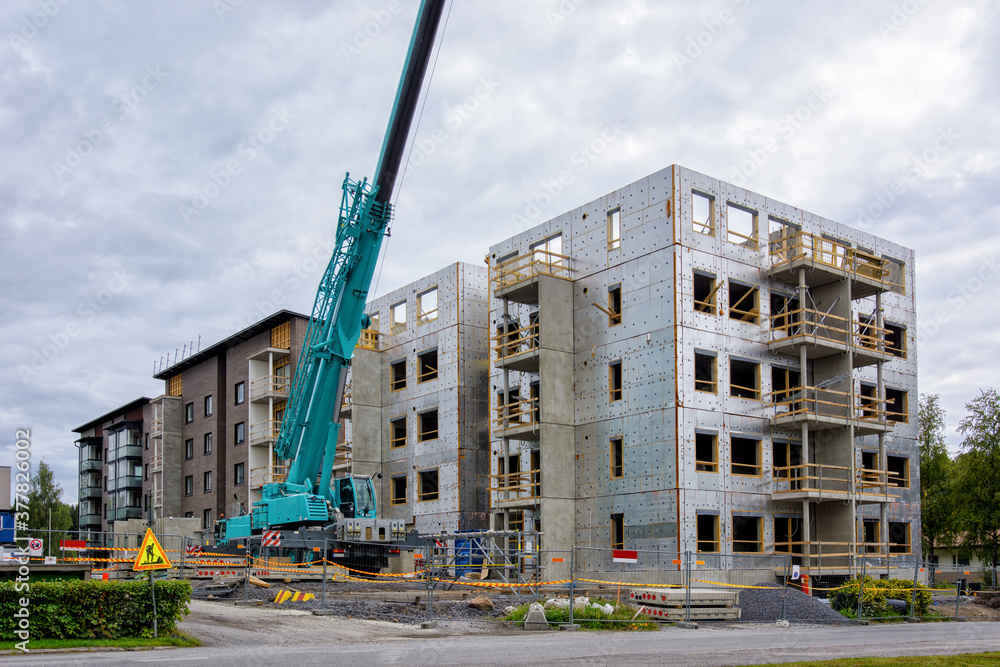 High rise building construction site with industrial mobile crane ...