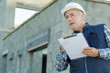 portrait of workman preparing estimate for work on house