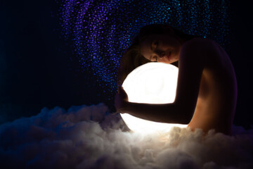 Wall Mural - portrait of beautiful young naked girl on the soft cloud hugs bright white moon isolated on amazing 