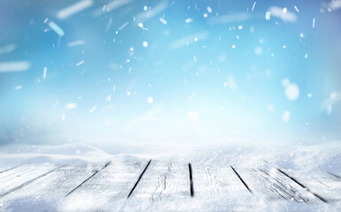 Wall Mural - beautiful winter snowy blurred defocused blue background and empty wooden flooring. flakes of snow f