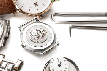 Watches and tools for repair on white background