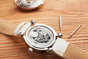 Disassembled watch on wooden table