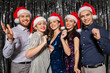 © Syda Productions - celebration, people and holiday concept - happy friends in santa hats at christmas party