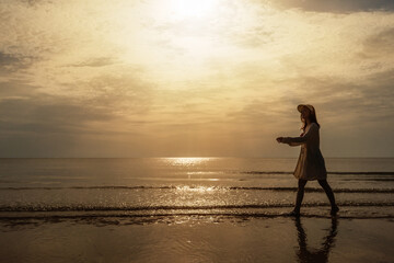 Wall Mural - cheerful woman in bikini walking on sea beach