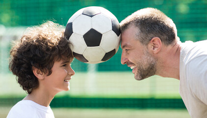 Wall Mural - Man holding ball between two heads with little boy