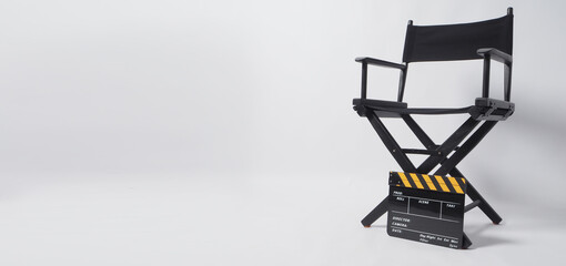 Wall Mural - Director chair with black and yellow clapper board or movie slate on white background.it is used in video production and film industry.