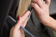 © Fotostudijas.lv - The hairdresser cuts the hair of a blonde woman.