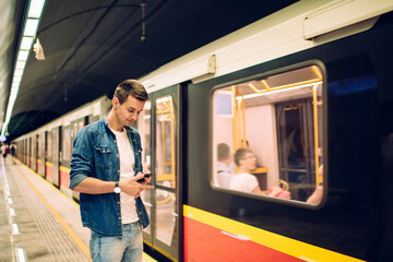 Thoughtful man surfing mobile phone in underground