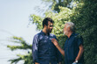 © chokniti - The happy elderly father and son spent time togerther with smiliing, laughing and talking at cozy home garden. Concept of freindly family