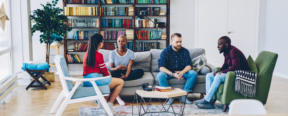 Multiethnic group of friends chatting at home