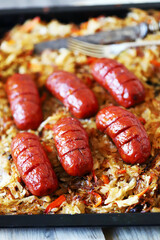 Wall Mural - Selective focus. Bavarian sausages with sauerkraut on a pan. Beer and pretzels. Oktoberfest food tray.