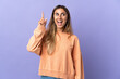 © luismolinero - Young hispanic woman over isolated purple background intending to realizes the solution while lifting a finger up